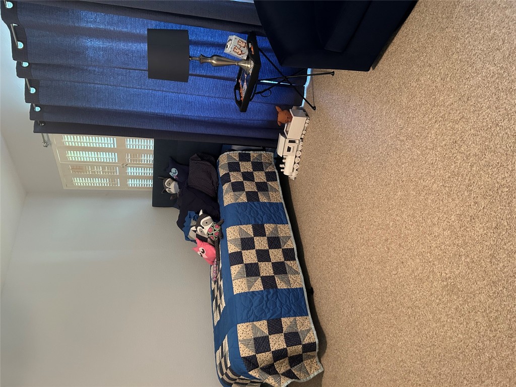 11121 Pinehurst Drive, Unit D Austin, TX 78747 - Photo 24 of 28 a bed room with furniture and a window