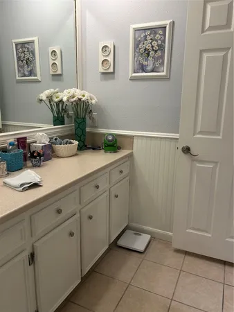 a spacious bathroom with a double vanity sink and a mirror