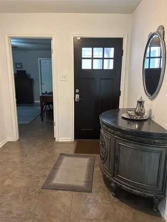 a living room with a mirror and a table