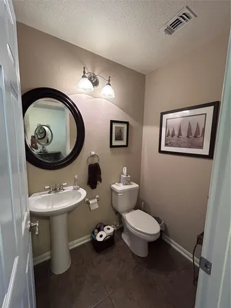 a bathroom with a toilet a sink and a mirror