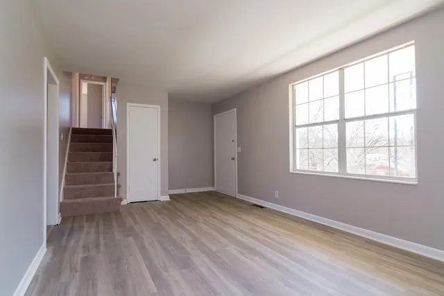 wooden floor in an empty room with a window