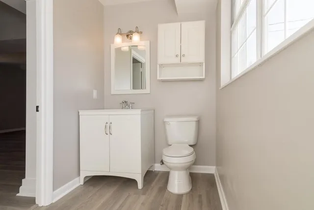 a white toilet sitting next to a bathroom sink