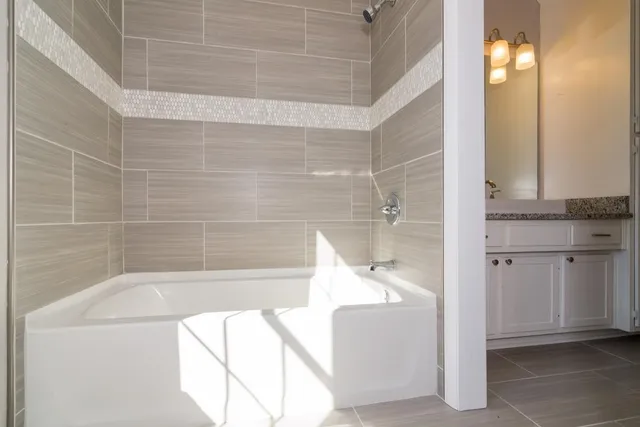 a bathroom with a bathtub and shower