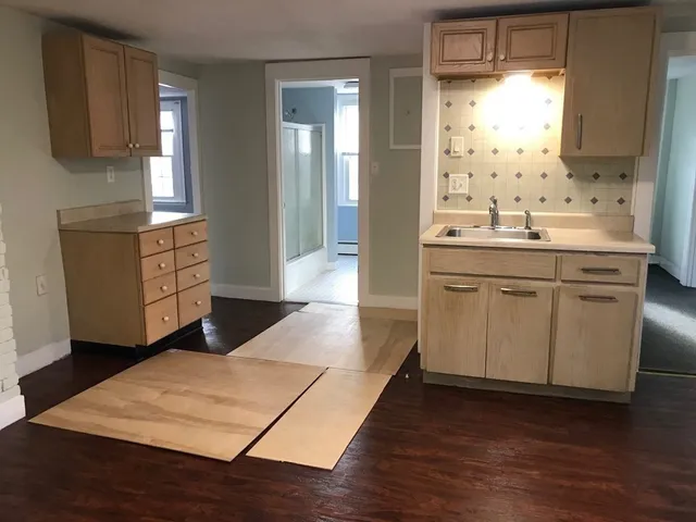 a kitchen with a sink stove and cabinets