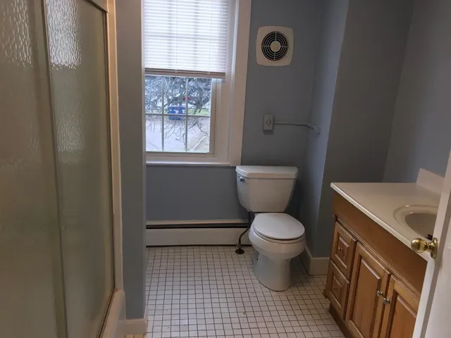 a bathroom with a toilet and a shower curtain