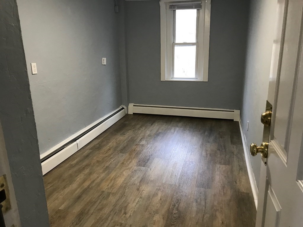 176 Plymouth Street, Unit 2 Bridgewater, MA 02324 - Photo 10 of 11 a view of a room with wooden floor and window