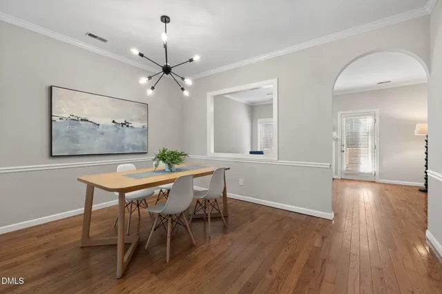 a view of a dining room with furniture wooden floor and chandelier