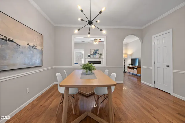 a view of a dining room with furniture and wooden floor
