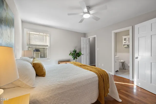 a bedroom with a bed and wooden floor