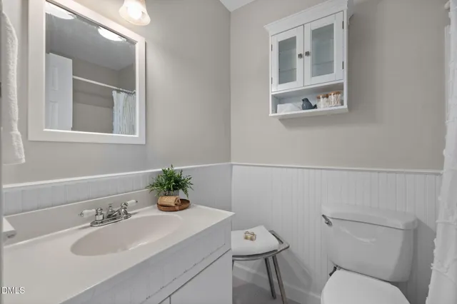 a bathroom with a sink mirror and toilet