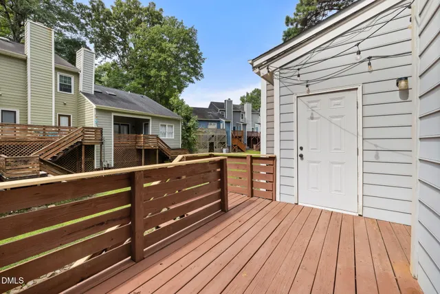 a view of a deck with wooden floor and barbeque oven