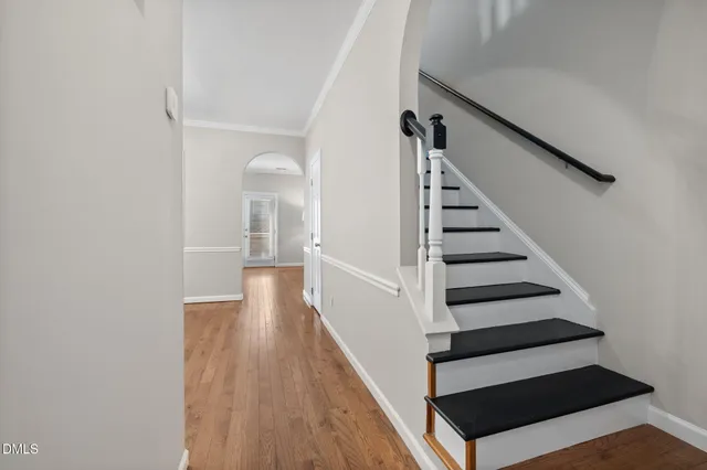 a view of entryway and hall with wooden floor