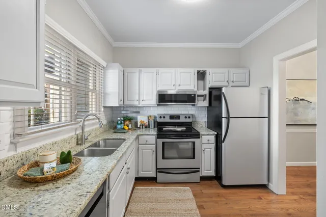 a kitchen with a refrigerator stove and sink