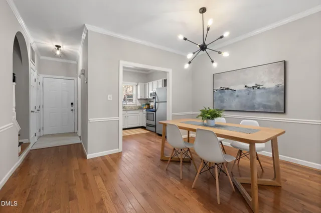 a view of a dining room with furniture and wooden floor