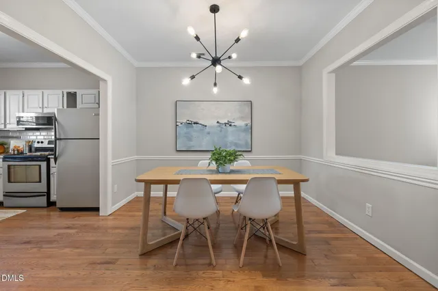 a view of a dining room with furniture and wooden floor