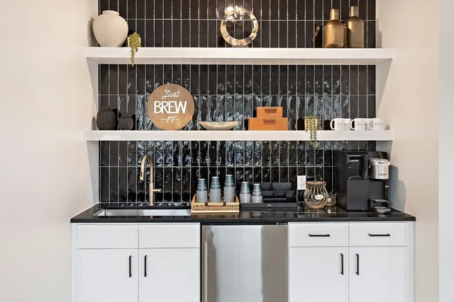 a kitchen with a stove top oven and cabinets