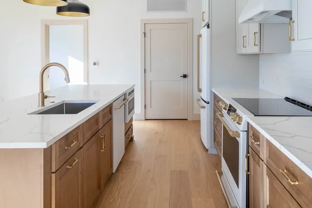 a kitchen with a sink and a refrigerator