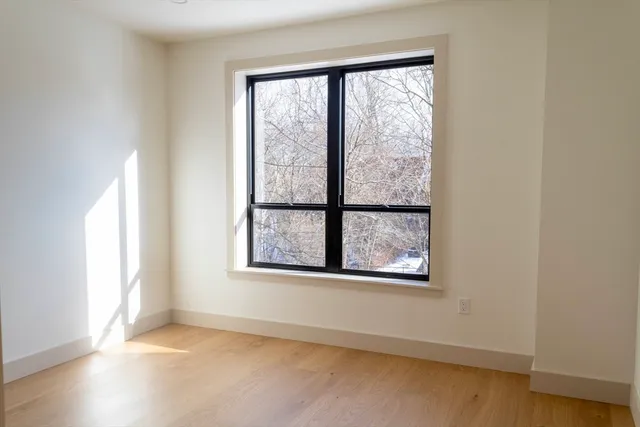 an empty room with windows and closet