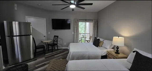 a living room with furniture a flat screen tv and a table