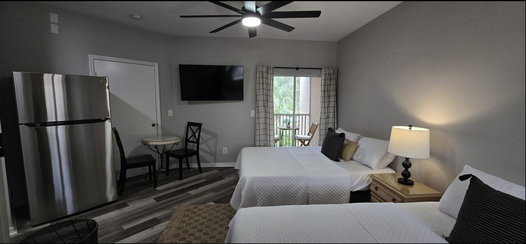 10047 Perfect Drive, Unit B Port St. Lucie, FL 34986 - Photo 1 of 13 a living room with furniture a flat screen tv and a table