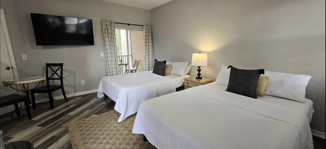 a bedroom with two beds and a television