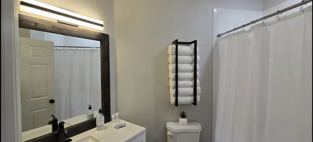 a bathroom with a shower curtain and a sink
