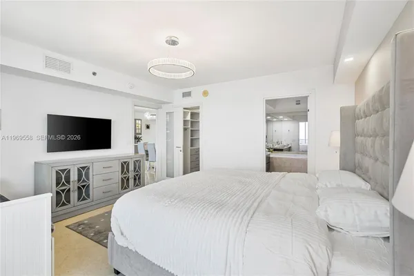 a bedroom with a flat screen television and a bed