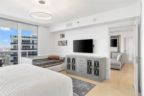 a bedroom with a bed and a flat screen tv
