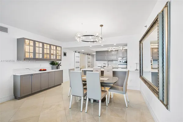a view of a dining room with furniture and a chandelier