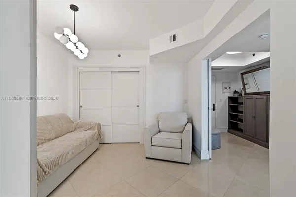 a living room with furniture and a chandelier