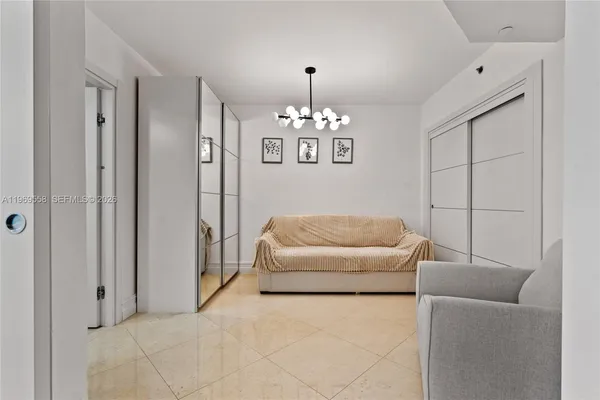 a bedroom with furniture and a chandelier
