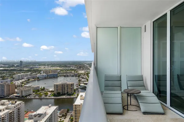 a view of a balcony with seating area