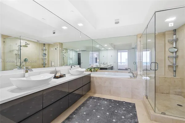 a large bathroom with a double vanity sink mirror and shower