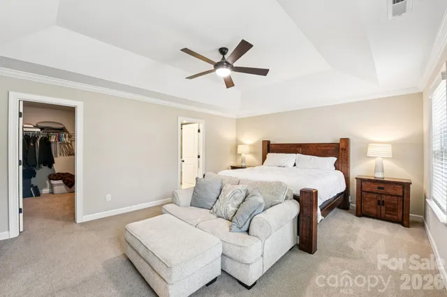 a bedroom with a bed and a large mirror