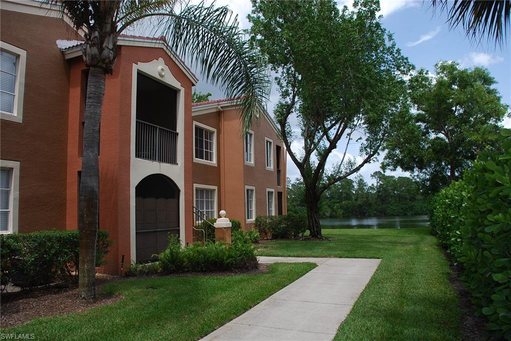 1130 Reserve Way, Unit 208 Naples, FL 34105 - Photo 11 of 14 a front view of a house with a yard