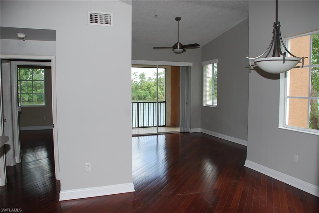 1130 Reserve Way, Unit 208 Naples, FL 34105 - Photo 12 of 14 a view of an empty room with wooden floor and a window
