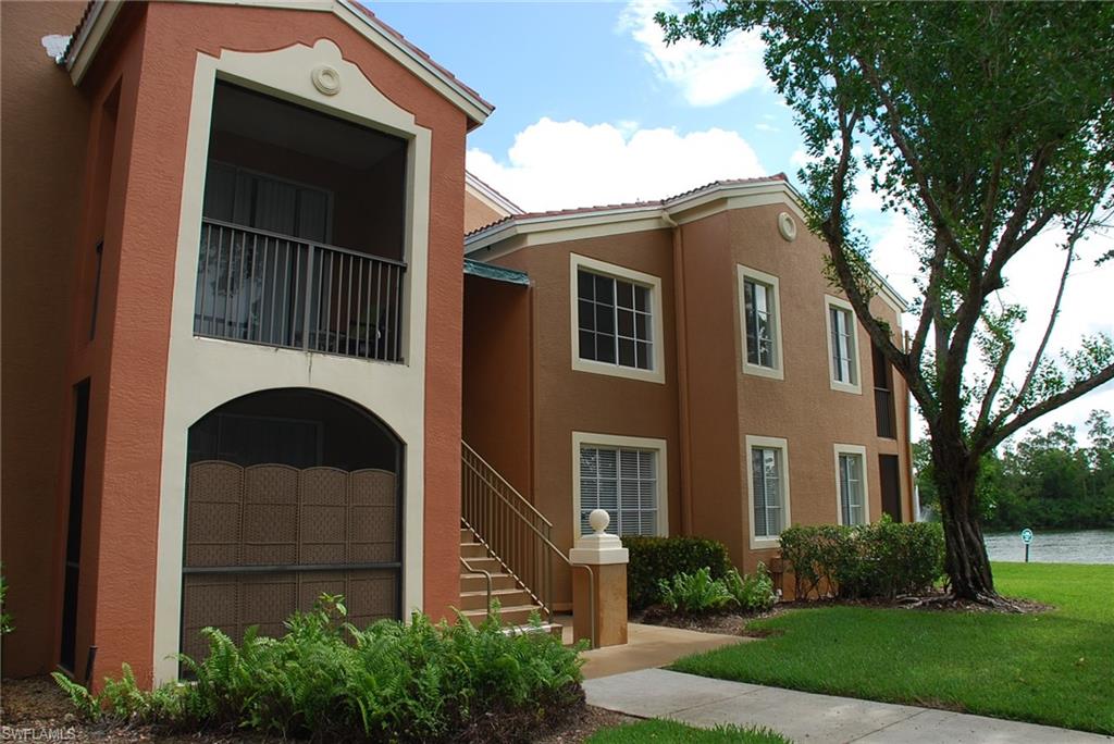 1130 Reserve Way, Unit 208 Naples, FL 34105 - Photo 2 of 14 a front view of a house with garden