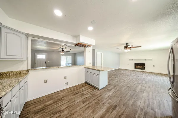 a spacious bathroom with a granite countertop sink and a mirror
