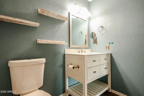 a bathroom with a double vanity sink mirror and toilet