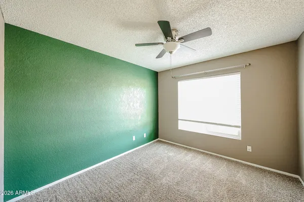 a view of a big room with carpet and windows