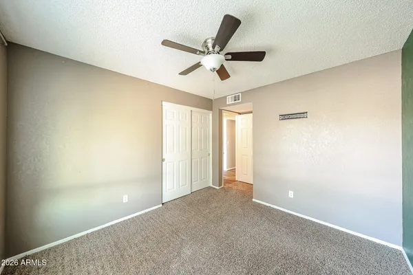 a view of a livingroom with a ceiling fan & window