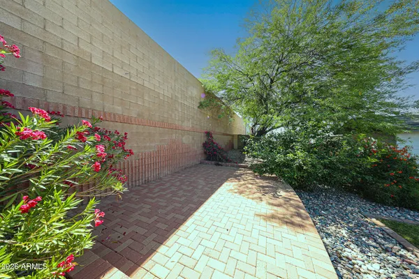 a view of a pathway with a flower garden