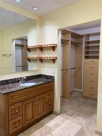 a kitchen with stainless steel appliances granite countertop a refrigerator and a stove