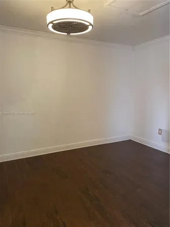 an empty room with wooden floor