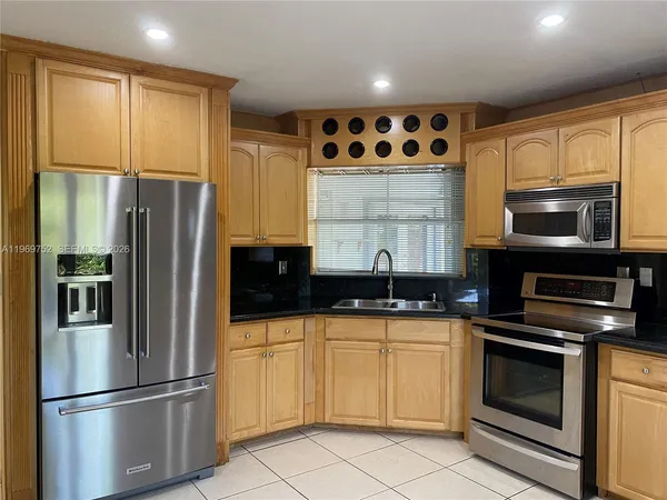 a kitchen with stainless steel appliances a refrigerator stove and microwave