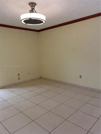 a view of a room with a chandelier fan