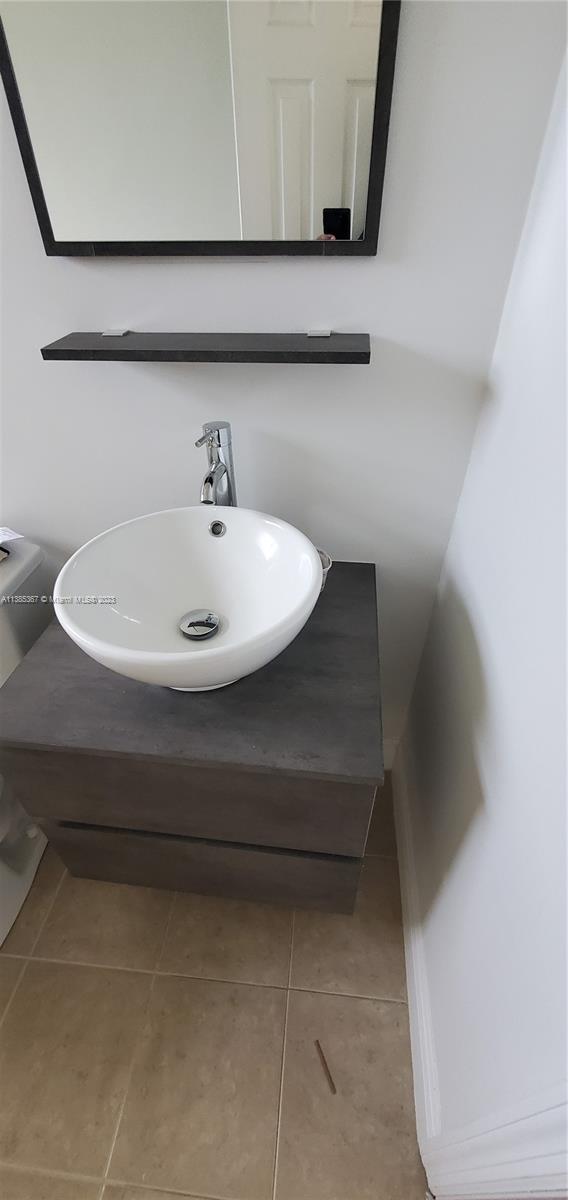 3787 Thomas, Unit 3787 Miami, FL 33133 - Photo 11 of 22 a bathroom with a sink and a mirror