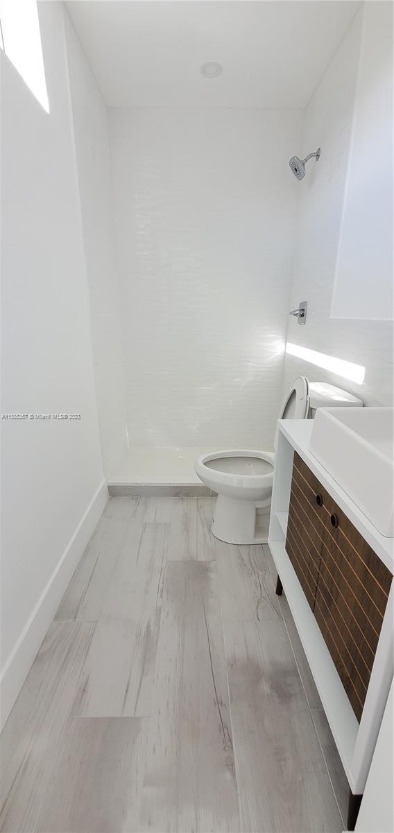 3787 Thomas, Unit 3787 Miami, FL 33133 - Photo 13 of 22 a bathroom with a toilet and a window