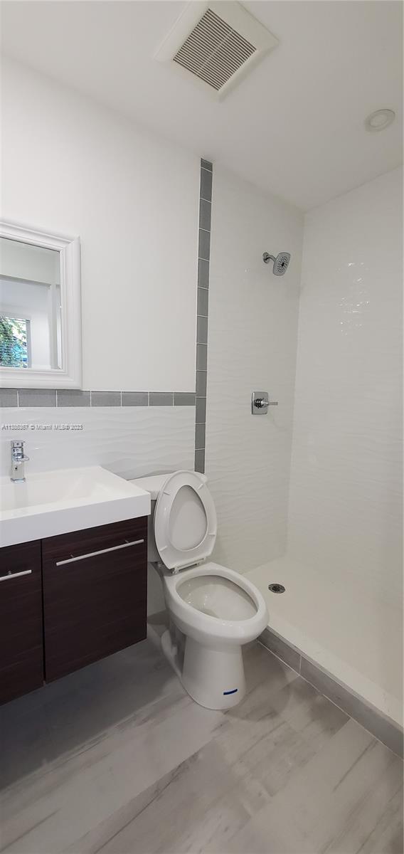 3787 Thomas, Unit 3787 Miami, FL 33133 - Photo 21 of 22 a bathroom with a sink a toilet and shower