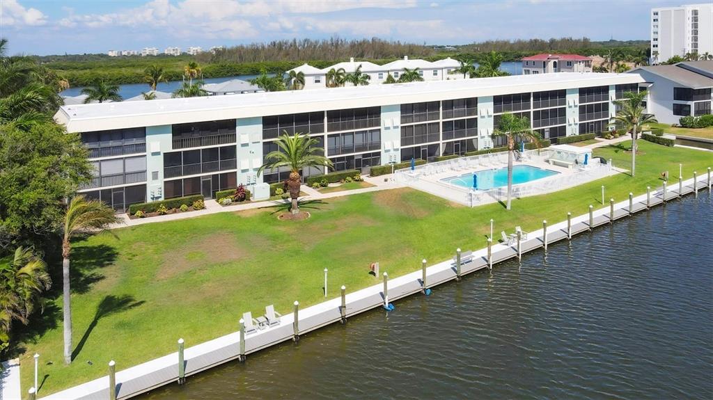 9200 Midnight Pass Road, Unit 24 Sarasota, FL 34242 - Photo 40 of 43 a view of a swimming pool with a lounge chairs